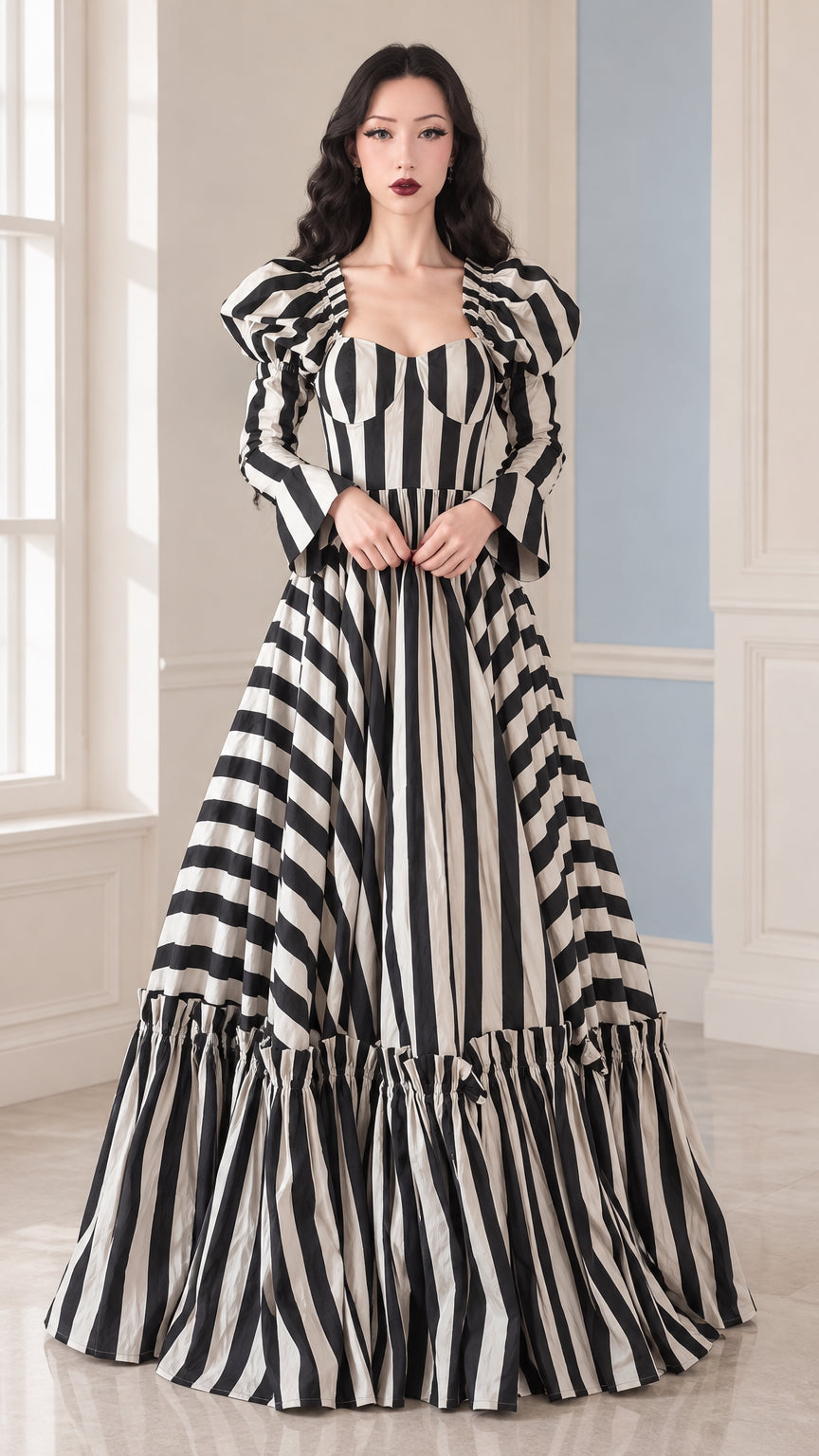 Front full view of woman wearing Black and White striped sweetheart puff sleeve tiered maxi gown