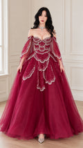 Front view of woman wearing burgundy off-the-shoulder beaded tulle ball gown