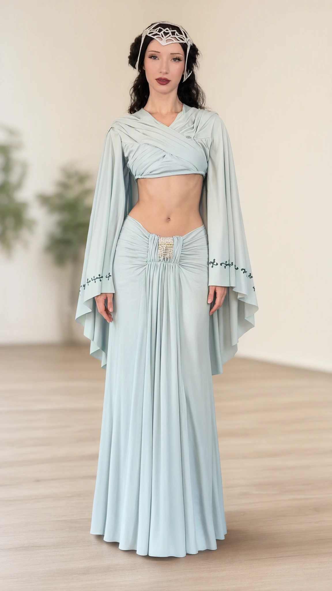 Front full-length view of model wearing light blue fantasy capelet crop top and ruched maxi skirt set