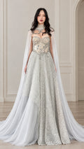 Full front view of silver embellished sweetheart evening gown with flowing sheer cape overlay