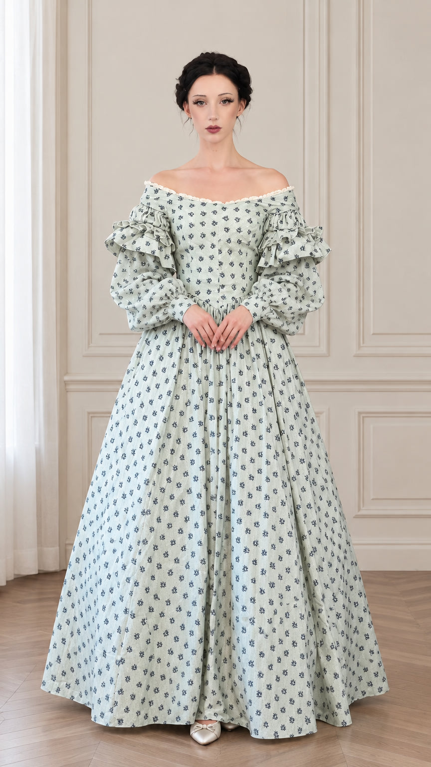 Front full view of woman wearing sage green vintage floral off-shoulder ball gown with tiered puff sleeves