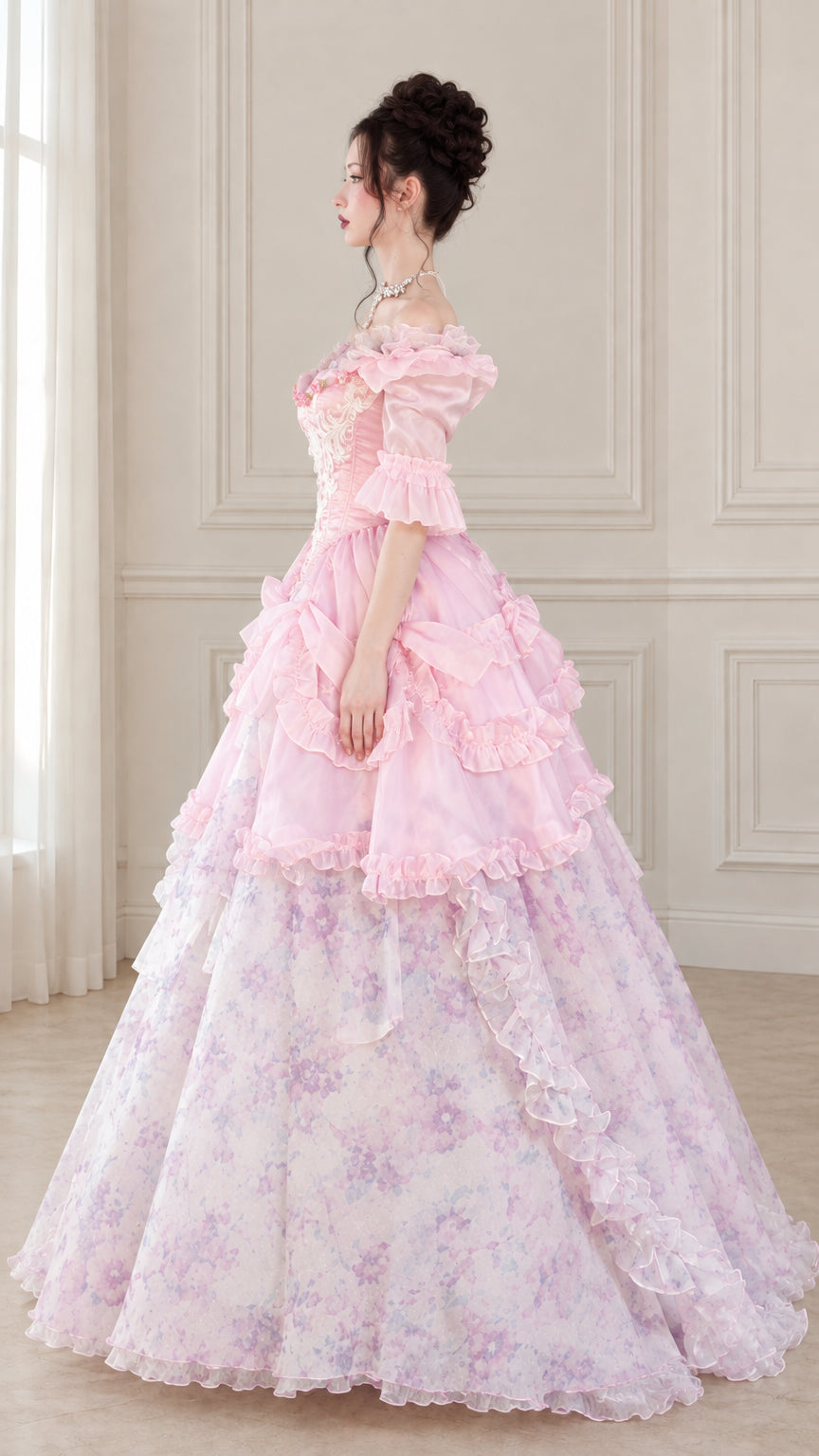 Side profile view of pink Victorian ball gown showing layered bustle and voluminous skirt