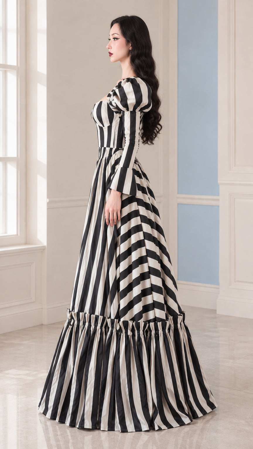 Side profile of woman modeling the Black and White striped voluminous maxi gown