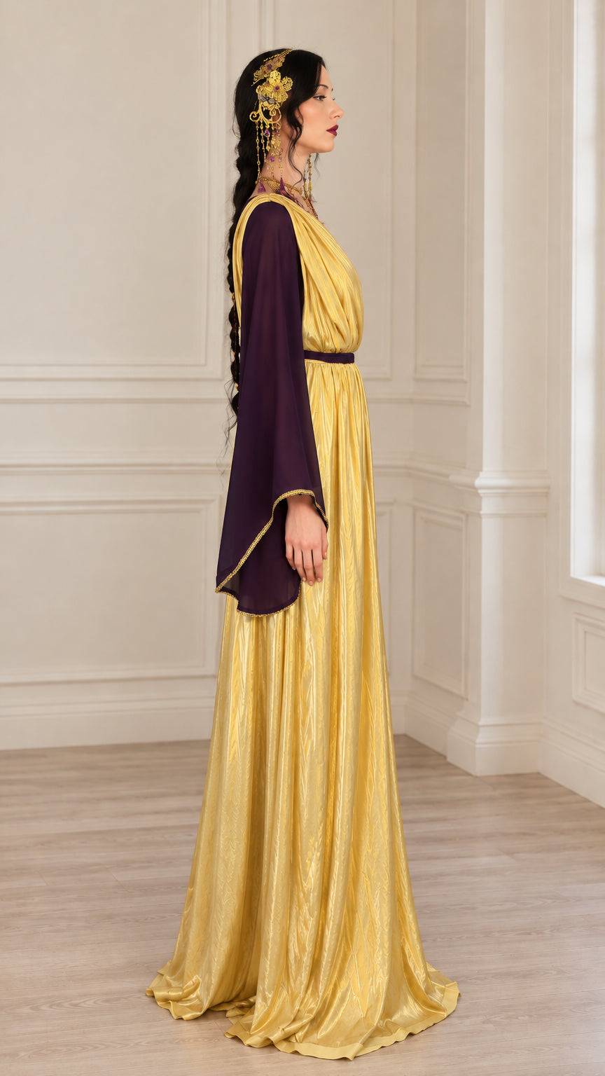 Side profile of model wearing purple and gold draped goddess maxi gown