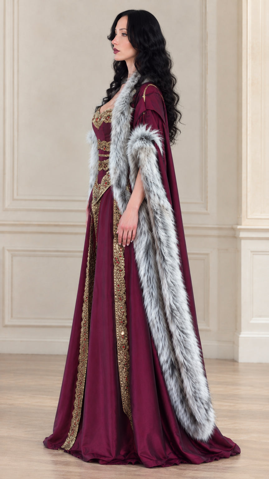 Side profile view of burgundy medieval gown showing flowing skirt and fur-trimmed cloak