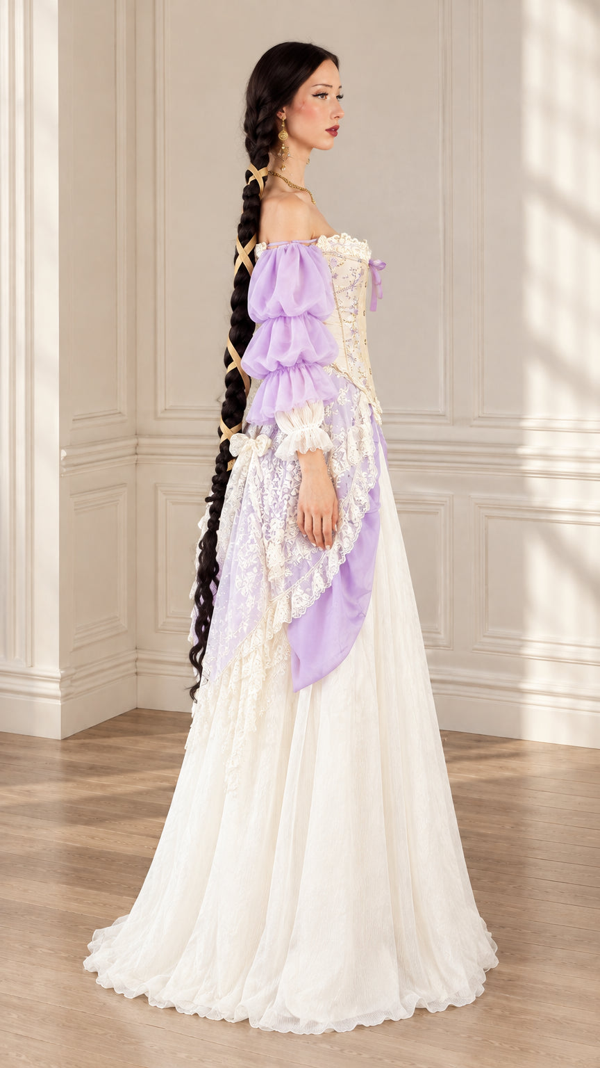 Side angle view of model showcasing draped lace panniers on lavender Renaissance ball gown