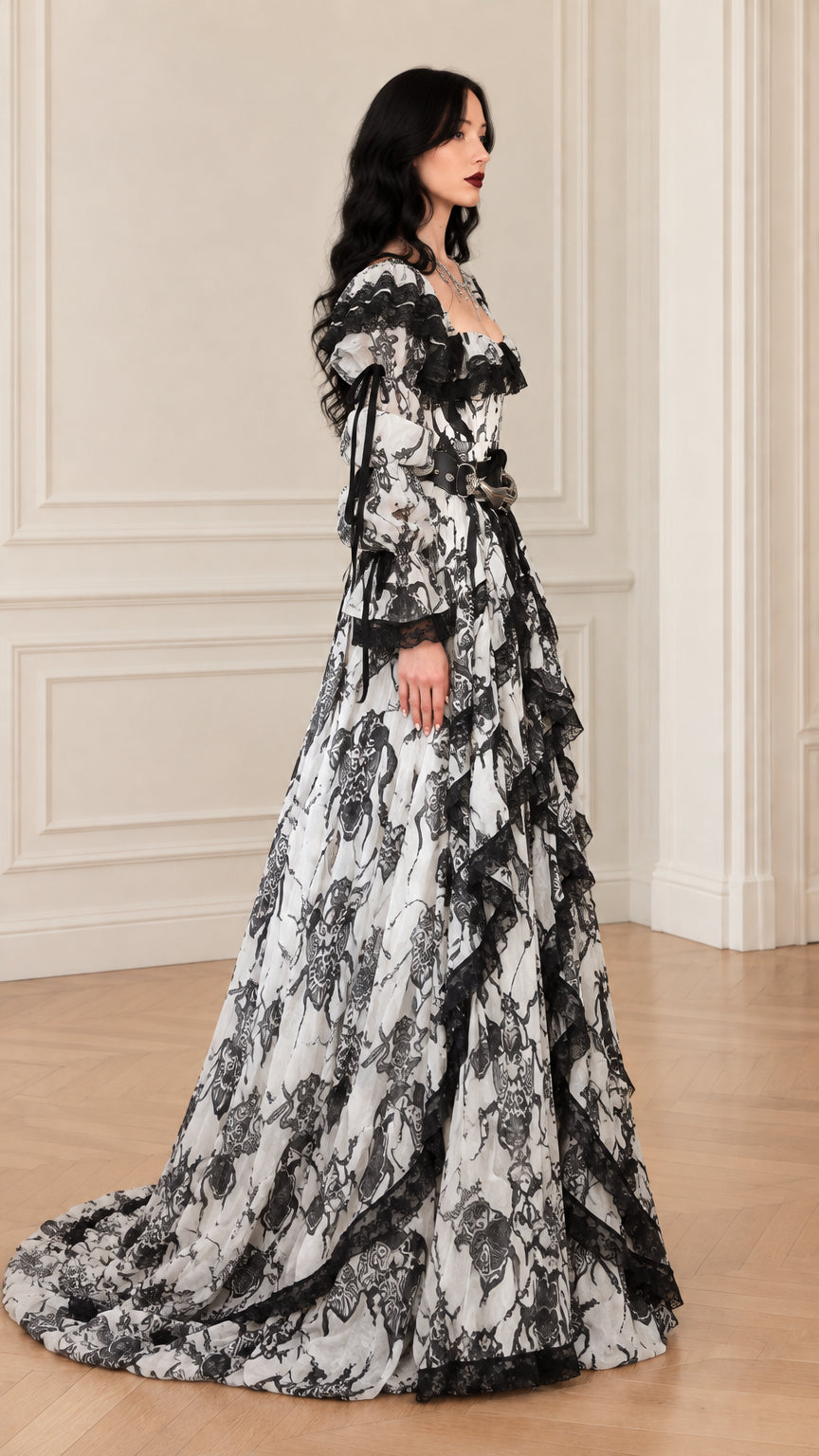 Side profile view of white and black baroque lace ballgown showing flowing tiered skirt