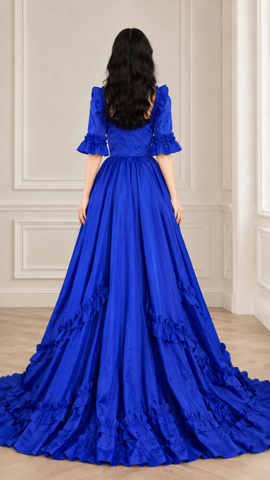 Back view of royal blue square back neckline and voluminous ruffled ball gown skirt