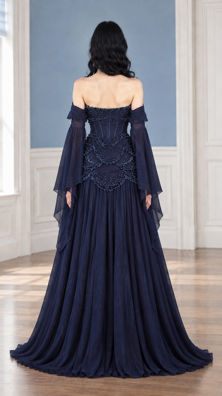 Back view of navy blue beaded corset evening gown showing back boning and flowing skirt