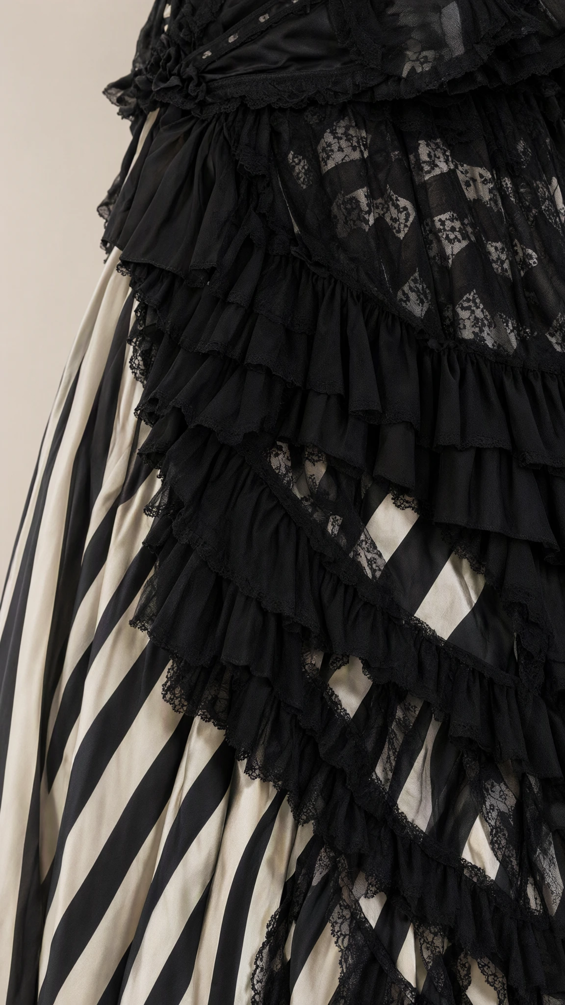 Close-up detail of the black lace trims, fabric ruffles, and vertical striped design