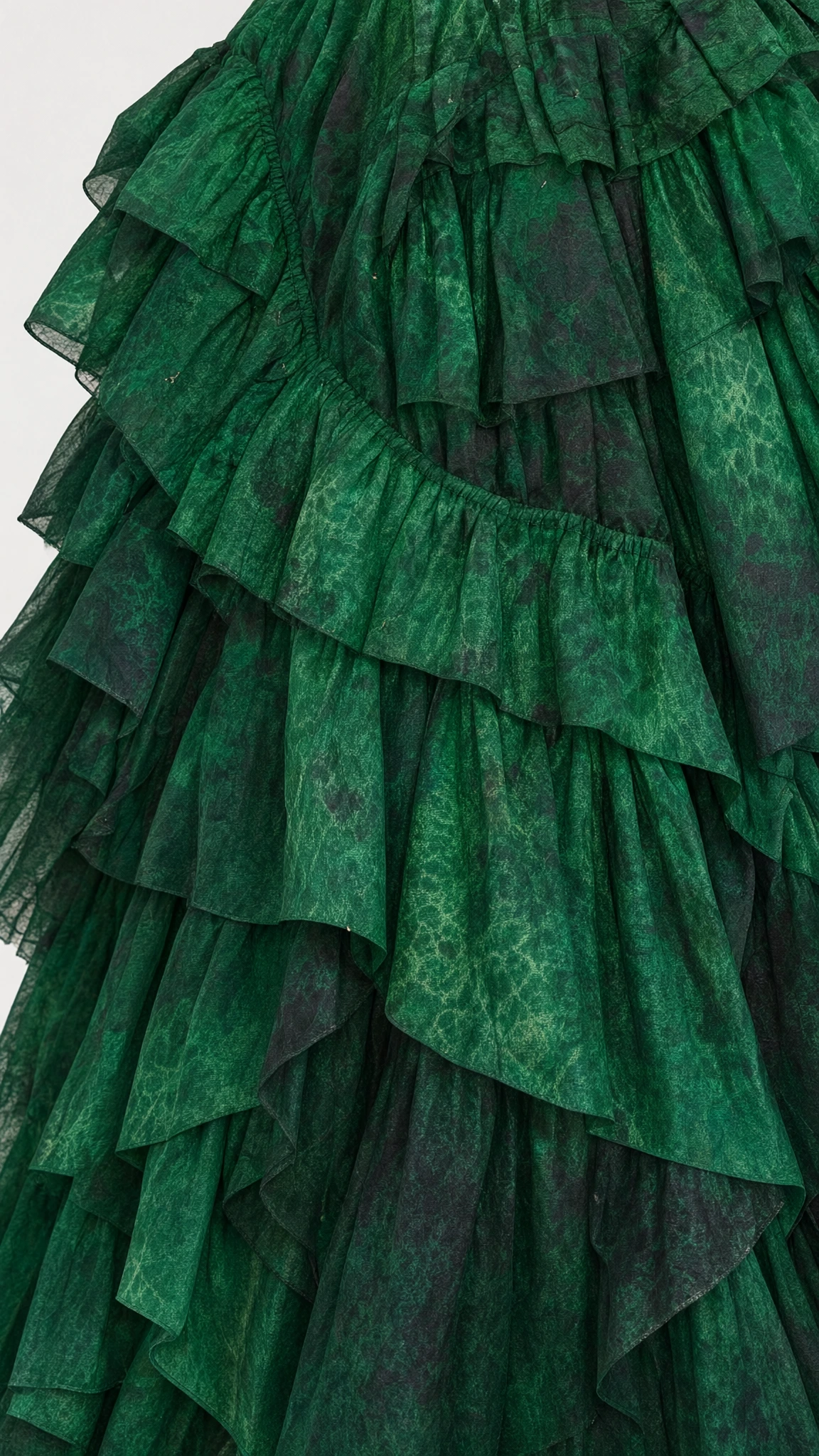 Close-up detail of the textured ruffled tiered skirt fabric in emerald green