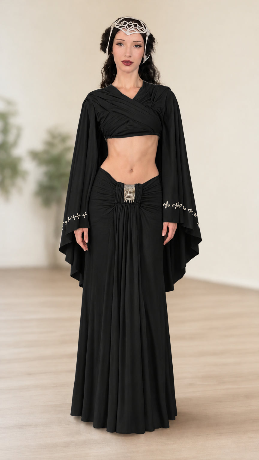 Front view of model wearing black fantasy wrap crop top and ruched maxi skirt set