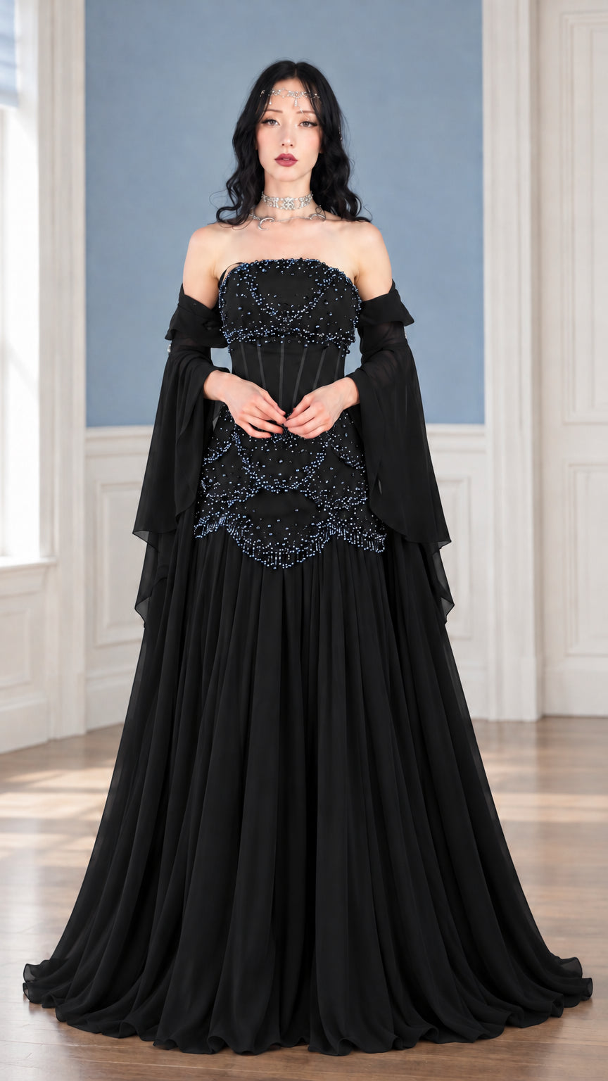 Front view of black strapless beaded corset gown with draped sleeve accents