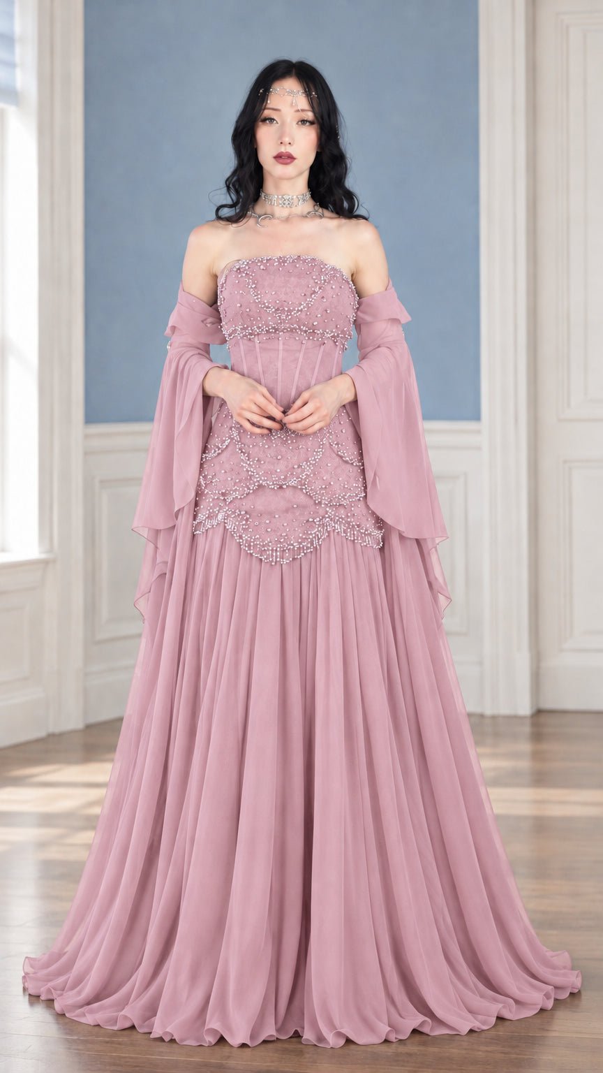 Front view of dusty pink strapless beaded corset formal gown with flowing maxi skirt