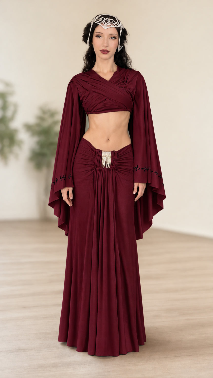 Front view of model wearing burgundy fantasy wrap crop top and ruched maxi skirt set