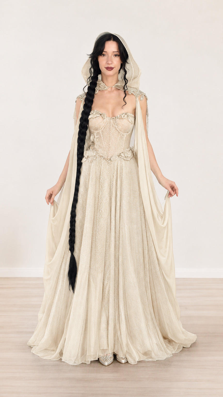 Full-length view of champagne beige hooded corset evening gown with sheer drape